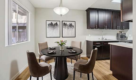 A modern dining room with a round table and chairs.