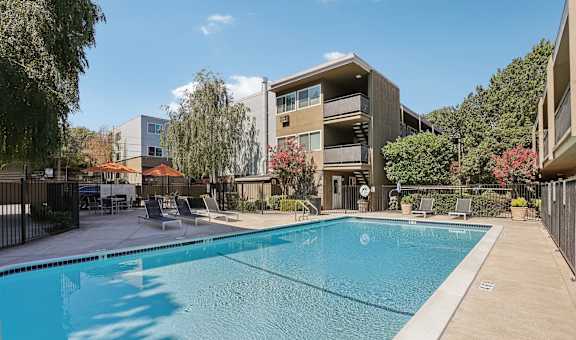 a swimming pool with a building in the background