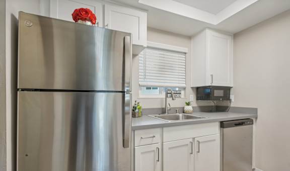 a kitchen with stainless steel appliances and white cabinets