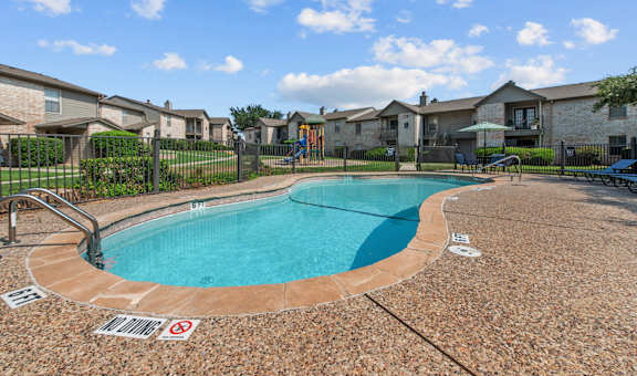 take a dip in the resort style pool at the whispering winds apartments in pearland, tx
