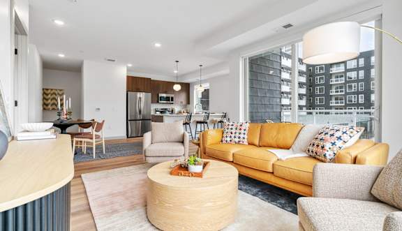 a living room with a couch and a table   and a balcony at The Mera, St Louis Park, MN