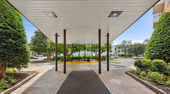 A covered walkway with a black surface and a white ceiling.