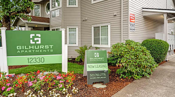 a house with a sign in front of a garden