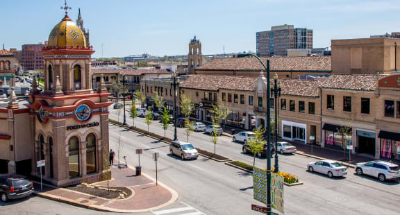 a view of a city street with a building with a clock tower