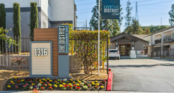 the sign at the entrance of the street in front of a building