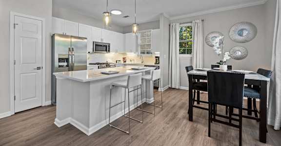 a kitchen with an island and a table with chairs