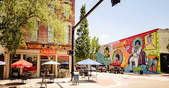 a street corner with a mural on the side of a building  at Canalside, Augusta, GA