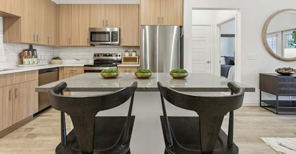 island kitchen with modern lighting at Tapestry Headwaters in Kissimmee, FL