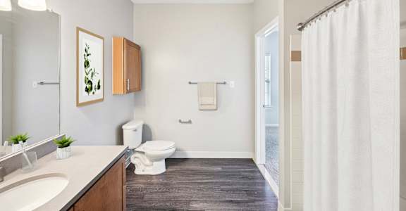 A bathroom with a white toilet and a white shower curtain.