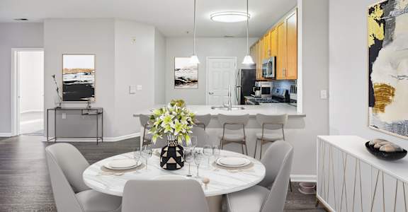 A dining room with a table set for a meal.