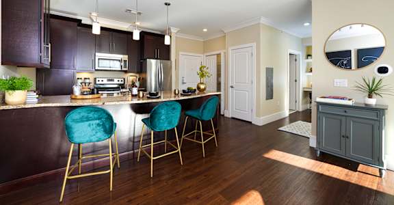 A kitchen with dark brown cabinets and a white counter top.