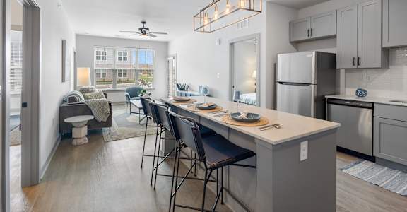 A kitchen with a table and chairs in the middle of the room.