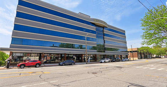 A large blue and grey building with a glass facade and a sign that reads "HSBC".