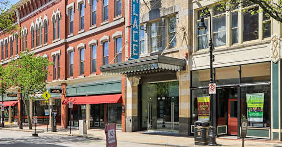 A street view of a building with a blue sign that says "The Palace".