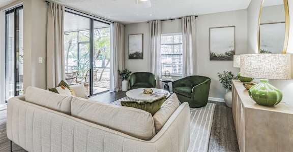 a living room with a couch and a table and a ceiling fan
