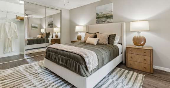 a bedroom with a bed and a ceiling fan