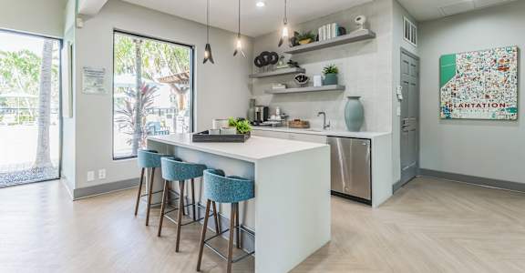 a kitchen with an island and stools in front of a white counter top