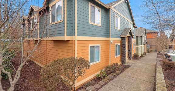 A house with a green and orange exterior is shown.