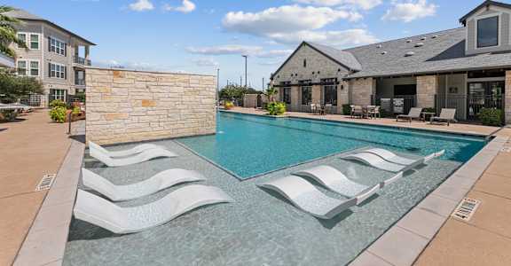 Shimmering Pool with white lounge chairs at Citadel at Westpointe, San Antonio, 78245