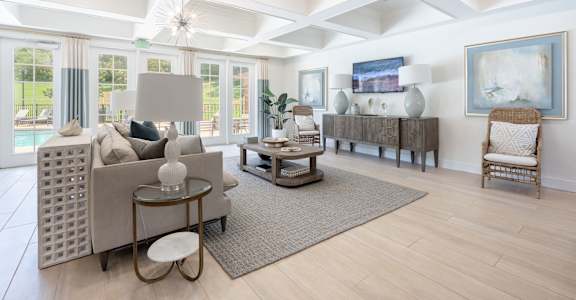A living room with a couch, a chair, and a table.