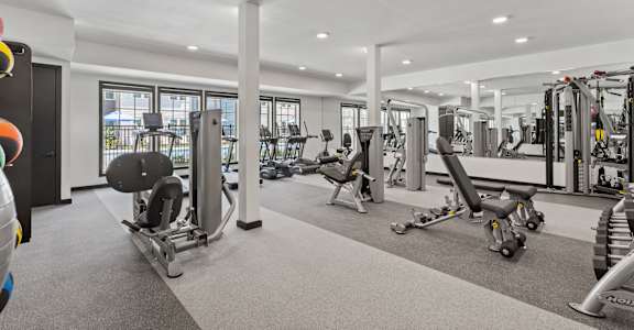 A spacious gym with a variety of equipment.
