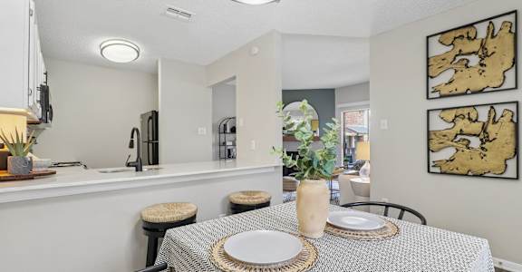 A dining room with a table set for two.
