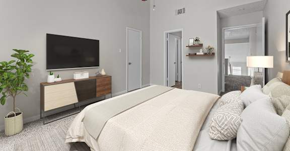 A bedroom with a large bed, a television, and a ceiling fan.