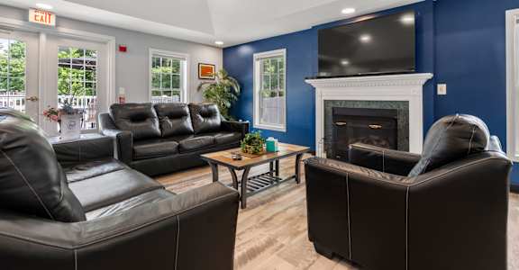 A living room with a fireplace and a television.