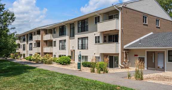 Apartment complex with a grassy area in front.