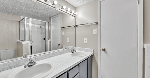 A bathroom with a sink, mirror, and lights.