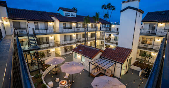a view of the courtyard of a hotel at night