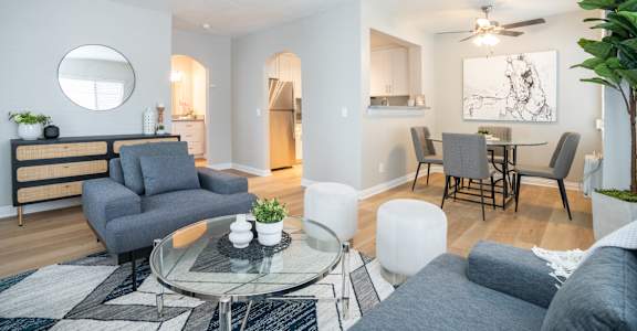 a living room with a couch and a glass coffee table