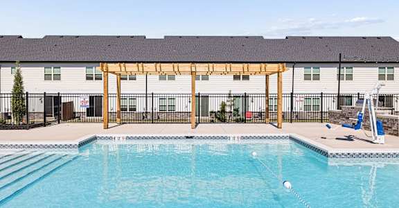 A swimming pool with a wooden structure above it.