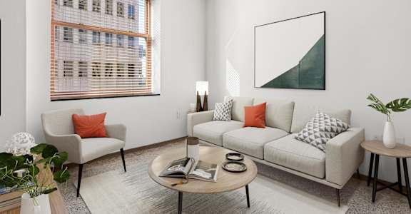 A living room with a couch, chair, and a painting on the wall.