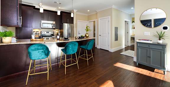 A kitchen with dark brown cabinets and a white counter top.