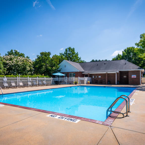 a swimming pool with a building in the background