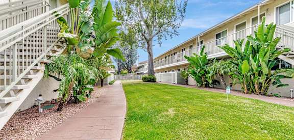 A sunny day at a residential area with apartment buildings and greenery.