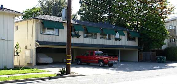 A red truck is parked in a garage.