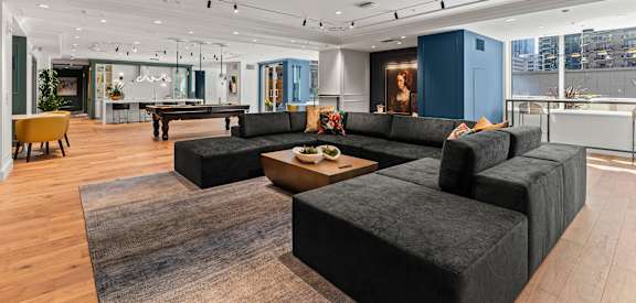 a large living room with couches and a pool table