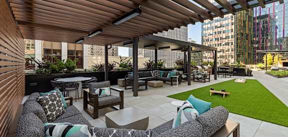 a lounge area with couches and tables on a patio
