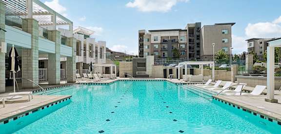 A large swimming pool in front of a building.