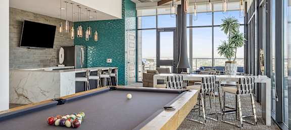 a game room with a pool table and a bar