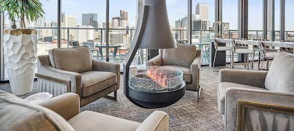 a living room filled with furniture and a fire pit