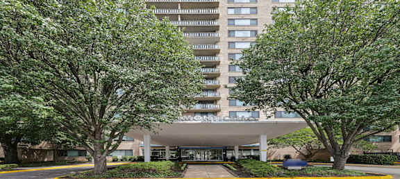 A large building with a parking lot in front of it.