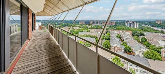 A balcony with a view of a cityscape.