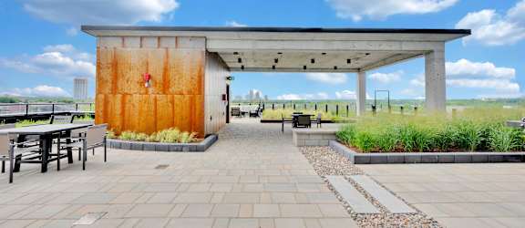 A large orange door is the centerpiece of a modern building.