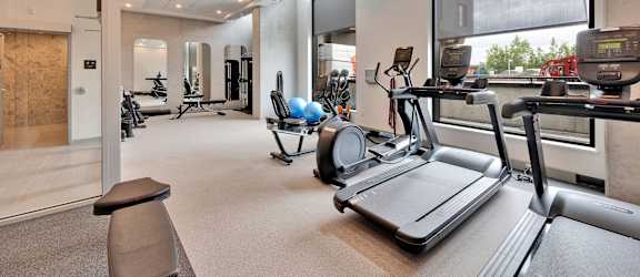 A gym with treadmills, exercise balls, and other equipment.