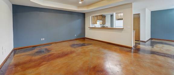 a living room with blue walls and a ceiling fan