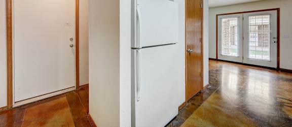 a kitchen with a refrigerator and a door
