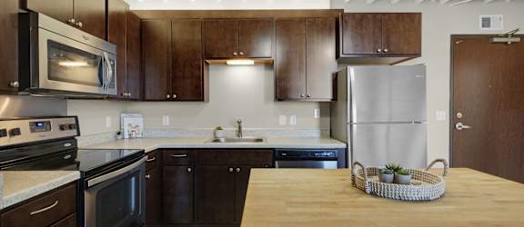 a kitchen with stainless steel appliances and wooden cabinets